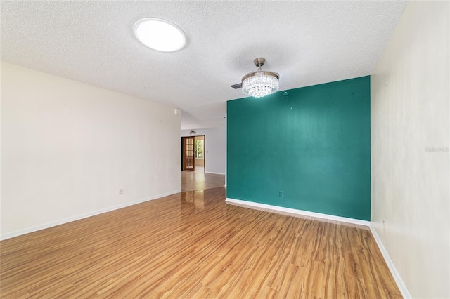 8881 SW 94th St Unit E, Ocala, FL 34481 - unfurnished room with light wood finished floors, a textured ceiling, and a ceiling fan