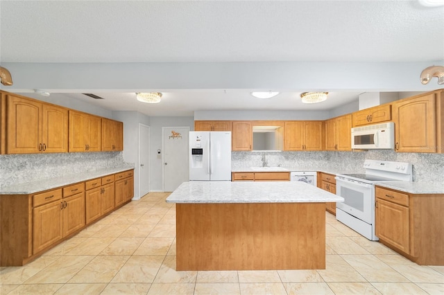 8881 SW 94th St Unit E, Ocala, FL 34481 - kitchen with white appliances, tasteful backsplash, a center island, light stone counters, and brown cabinetry