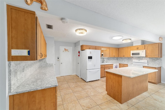 8881 SW 94th St Unit E, Ocala, FL 34481 - kitchen with white appliances, a textured ceiling, backsplash, a kitchen island, and light stone counters
