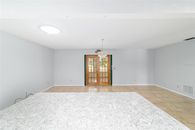8881 SW 94th St Unit E, Ocala, FL 34481 - empty room featuring light tile patterned floors and a chandelier