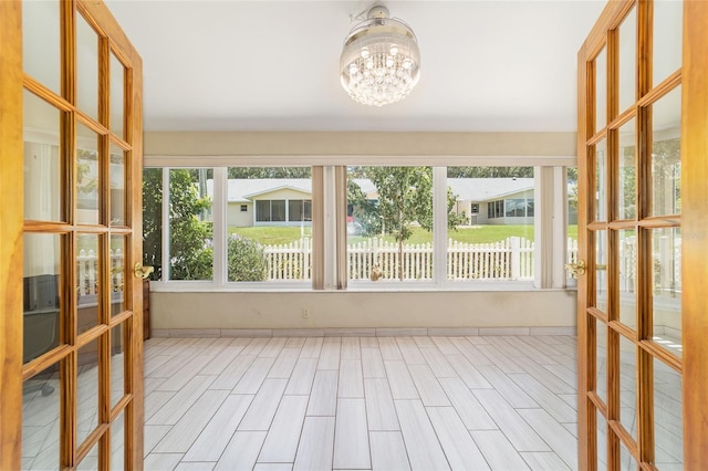 8881 SW 94th St Unit E, Ocala, FL 34481 - unfurnished sunroom featuring a chandelier and french doors
