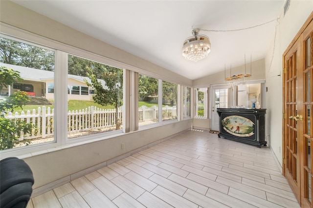 8881 SW 94th St Unit E, Ocala, FL 34481 - unfurnished sunroom featuring a chandelier and vaulted ceiling