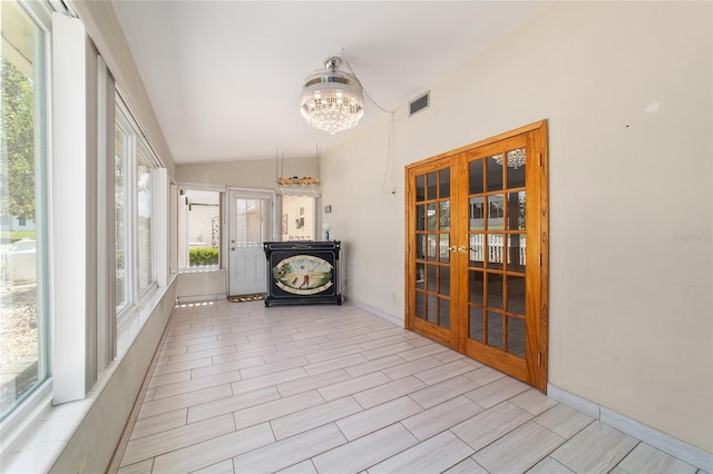 8881 SW 94th St Unit E, Ocala, FL 34481 - sunroom with french doors, lofted ceiling, and a chandelier