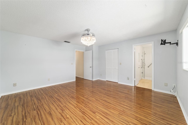 8881 SW 94th St Unit E, Ocala, FL 34481 - spare room with a chandelier and wood finished floors