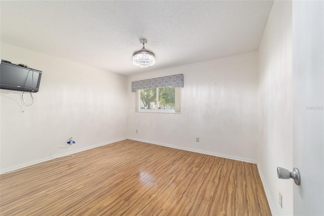 8881 SW 94th St Unit E, Ocala, FL 34481 - unfurnished room with light wood-style flooring and a textured ceiling