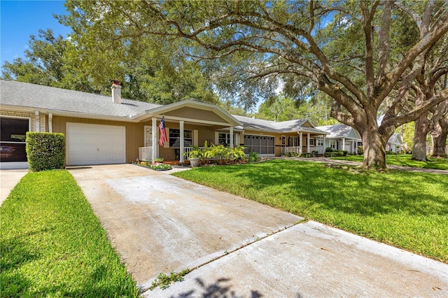 8850 SW 97th St Unit C, Ocala, FL 34481 - ranch-style house featuring driveway, an attached garage, a chimney, a porch, and a front yard