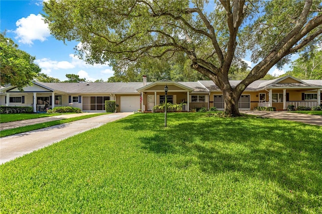 8850 SW 97th St Unit C, Ocala, FL 34481 - single story home with concrete driveway, a garage, a front yard, and covered porch