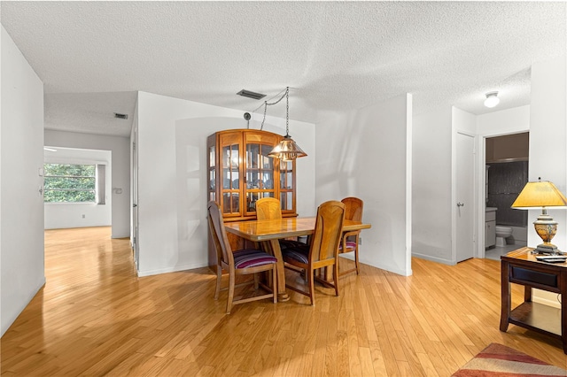 8850 SW 97th St Unit C, Ocala, FL 34481 - dining room featuring light wood-style floors and a textured ceiling