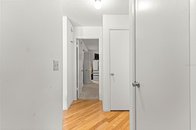 8850 SW 97th St Unit C, Ocala, FL 34481 - corridor with light wood-style floors and a textured ceiling