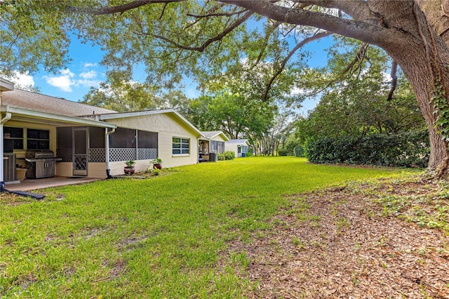 8850 SW 97th St Unit C, Ocala, FL 34481 - view of green lawn with a sunroom and a patio area