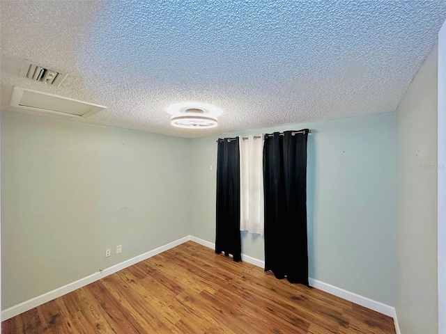 6806 Monique Ave, Tampa, FL 33625 - spare room with wood finished floors and a textured ceiling