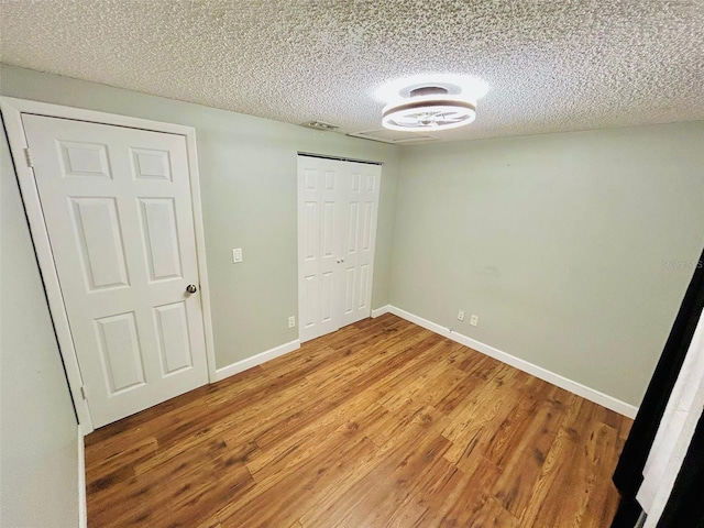 6806 Monique Ave, Tampa, FL 33625 - unfurnished bedroom with light wood-style floors, a textured ceiling, and a closet