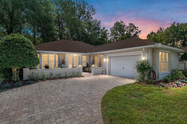 7242 SW 115th Pl, Ocala, FL 34476 - ranch-style house featuring a garage, driveway, and a shingled roof