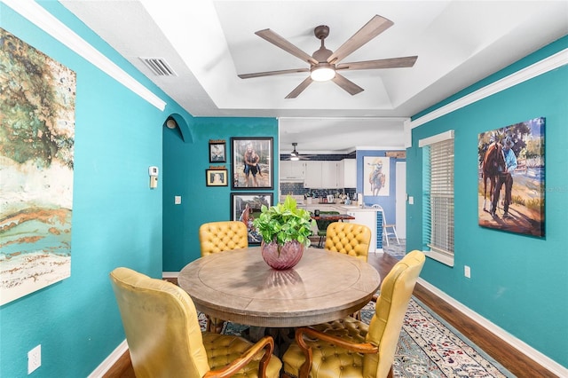 7242 SW 115th Pl, Ocala, FL 34476 - dining area with a raised ceiling, a ceiling fan, and wood finished floors