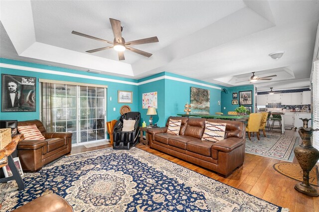 7242 SW 115th Pl, Ocala, FL 34476 - living area featuring a tray ceiling, ceiling fan, and hardwood / wood-style floors