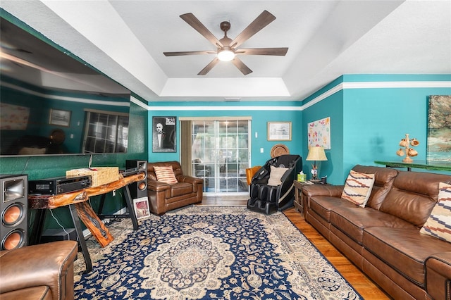 7242 SW 115th Pl, Ocala, FL 34476 - living room with a tray ceiling, wood finished floors, and ceiling fan