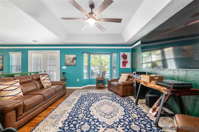 7242 SW 115th Pl, Ocala, FL 34476 - living area with a ceiling fan, a raised ceiling, and wood finished floors
