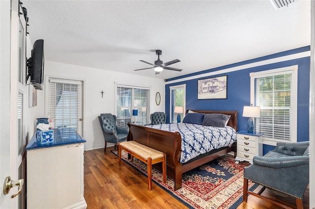 7242 SW 115th Pl, Ocala, FL 34476 - bedroom featuring wood finished floors, multiple windows, a ceiling fan, and a textured ceiling