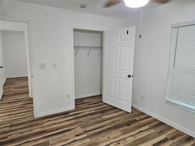 51 NE 10th St, Williston, FL 32696 - unfurnished bedroom with wood finished floors, a closet, and a ceiling fan