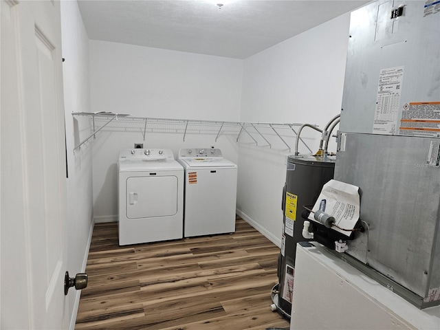 51 NE 10th St, Williston, FL 32696 - laundry room featuring separate washer and dryer, heating unit, water heater, and wood finished floors