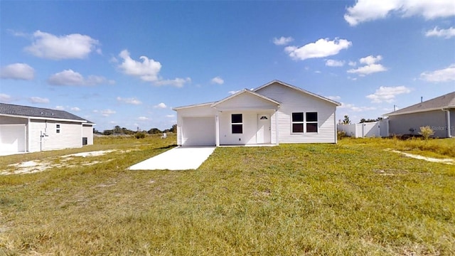 2728 SW 147th Ter, Ocala, FL 34481 - back of house with a yard, an attached garage, and driveway