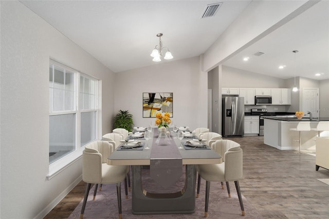 2766 W Santana Dr, Citrus Springs, FL 34433 - dining space with vaulted ceiling, a chandelier, wood finished floors, and recessed lighting