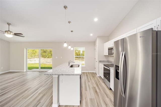 2766 W Santana Dr, Citrus Springs, FL 34433 - kitchen with appliances with stainless steel finishes, white cabinets, light wood-style floors, plenty of natural light, and recessed lighting