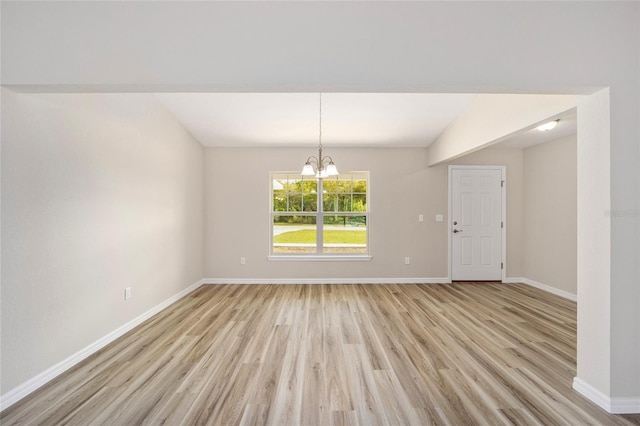 2766 W Santana Dr, Citrus Springs, FL 34433 - unfurnished dining area with light wood-type flooring, a chandelier, and lofted ceiling