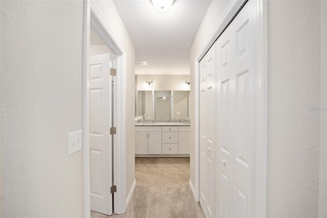2766 W Santana Dr, Citrus Springs, FL 34433 - hallway featuring light colored carpet and light tile patterned floors