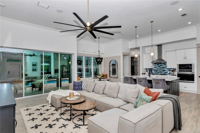 3196 W Mustang Blvd, Beverly Hills, FL 34465 - living area featuring a ceiling fan, crown molding, light wood-style floors, and recessed lighting