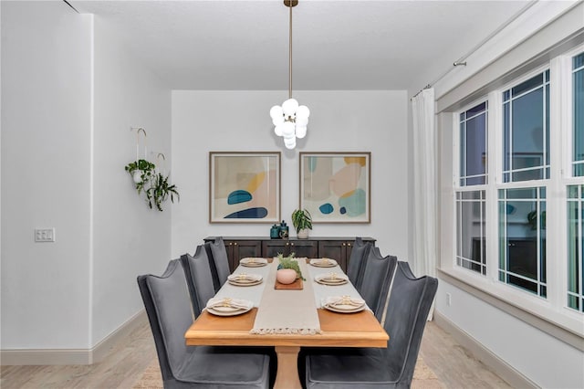 3196 W Mustang Blvd, Beverly Hills, FL 34465 - dining room with light wood-style flooring and a chandelier