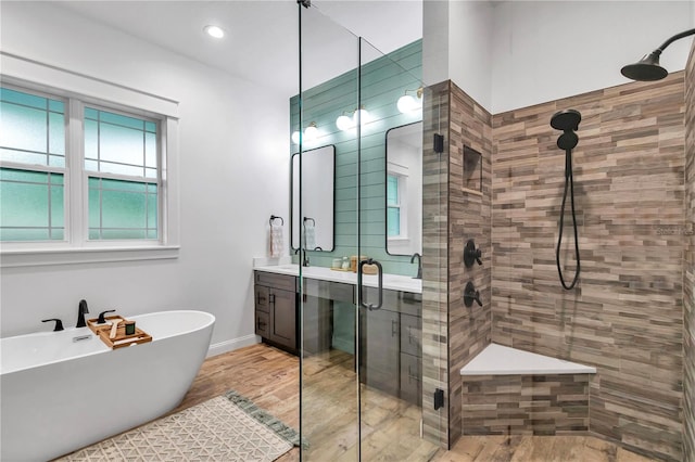 3196 W Mustang Blvd, Beverly Hills, FL 34465 - bathroom with a stall shower, vanity, a freestanding tub, wood finished floors, and recessed lighting