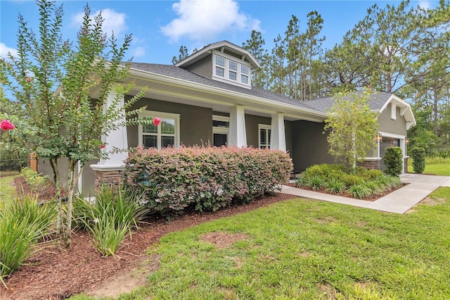 3196 W Mustang Blvd, Beverly Hills, FL 34465 - view of front facade with stucco siding, a front yard, and stone siding