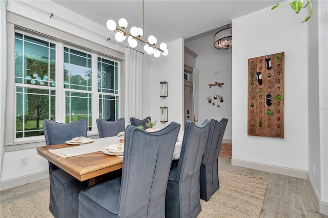 3196 W Mustang Blvd, Beverly Hills, FL 34465 - dining room featuring light wood-style floors, healthy amount of natural light, and a chandelier