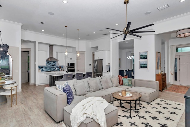 3196 W Mustang Blvd, Beverly Hills, FL 34465 - living room featuring light wood-style floors, a ceiling fan, a chandelier, ornamental molding, and recessed lighting
