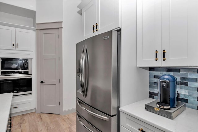 3196 W Mustang Blvd, Beverly Hills, FL 34465 - kitchen featuring appliances with stainless steel finishes, backsplash, light countertops, and white cabinetry