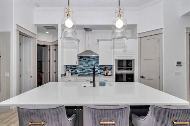 3196 W Mustang Blvd, Beverly Hills, FL 34465 - kitchen featuring appliances with stainless steel finishes, wall chimney range hood, backsplash, white cabinetry, and ornamental molding