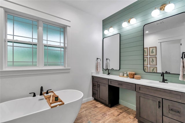 3196 W Mustang Blvd, Beverly Hills, FL 34465 - full bath with wood walls, double vanity, a freestanding bath, and wood finished floors