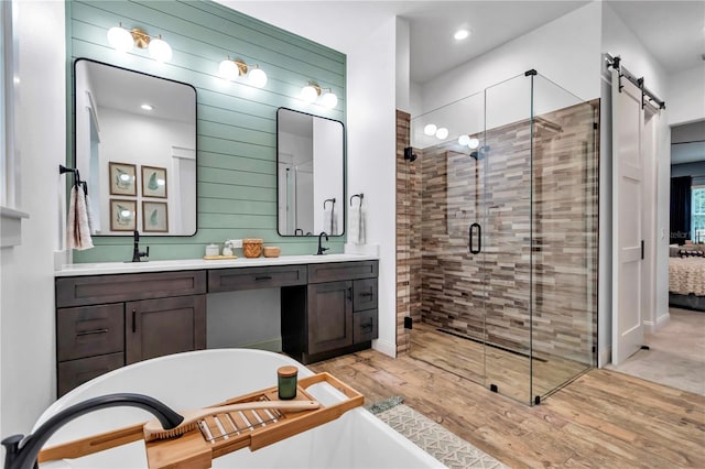 3196 W Mustang Blvd, Beverly Hills, FL 34465 - ensuite bathroom with a soaking tub, a shower stall, double vanity, wood finished floors, and recessed lighting