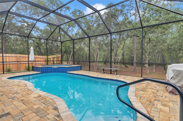3196 W Mustang Blvd, Beverly Hills, FL 34465 - view of pool with a patio area, a fenced backyard, a pool with connected hot tub, and glass enclosure