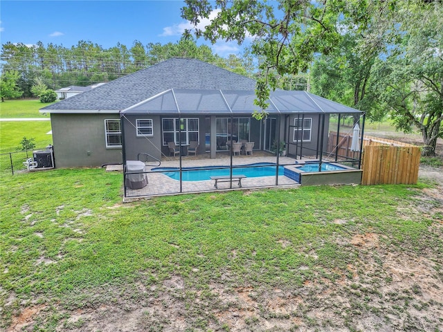3196 W Mustang Blvd, Beverly Hills, FL 34465 - rear view of house with a patio, a fenced backyard, glass enclosure, a shingled roof, and a pool with connected hot tub
