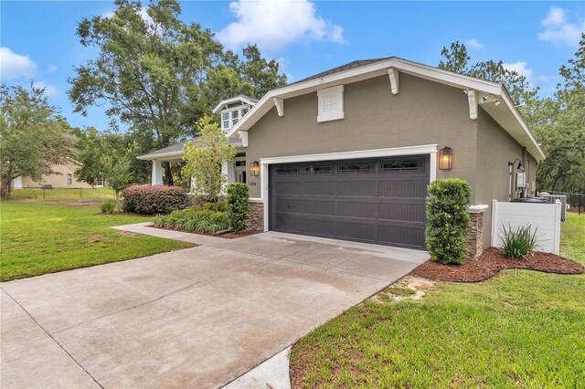 3196 W Mustang Blvd, Beverly Hills, FL 34465 - view of front of property featuring stucco siding, driveway, a garage, and stone siding