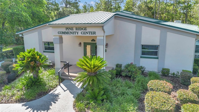 3196 W Mustang Blvd, Beverly Hills, FL 34465 - view of front facade with stucco siding and a metal roof