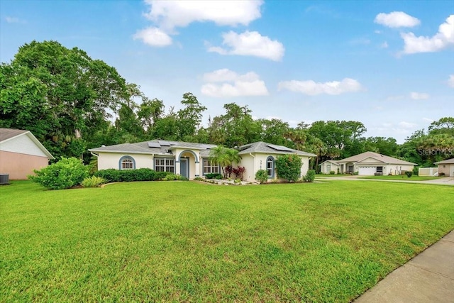 3769 Grove View Ln, Port Orange, FL 32129 - ranch-style house featuring solar panels, a front lawn, and stucco siding