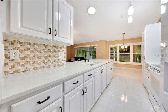 3769 Grove View Ln, Port Orange, FL 32129 - kitchen with white appliances, light tile patterned floors, backsplash, and white cabinets