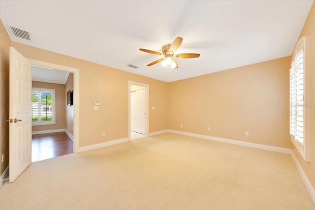 3769 Grove View Ln, Port Orange, FL 32129 - spare room featuring light carpet and ceiling fan