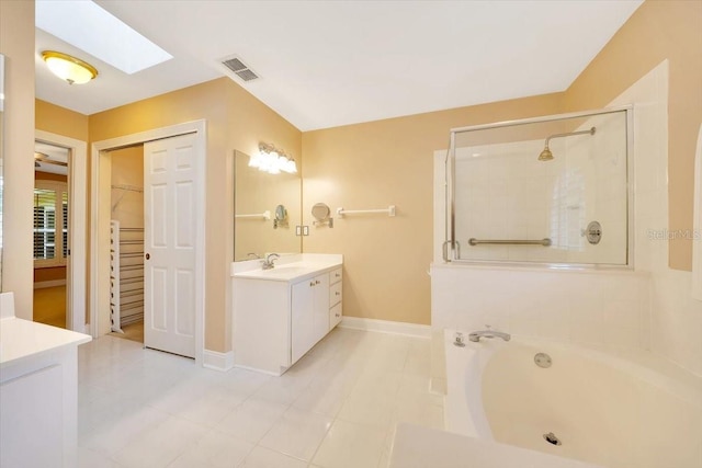 3769 Grove View Ln, Port Orange, FL 32129 - bathroom with vanity, a skylight, a spacious closet, and a bath