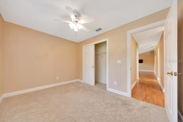 3769 Grove View Ln, Port Orange, FL 32129 - unfurnished bedroom with light carpet, a closet, and a ceiling fan
