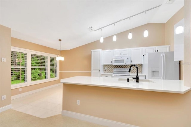 3769 Grove View Ln, Port Orange, FL 32129 - kitchen featuring vaulted ceiling, white appliances, decorative backsplash, pendant lighting, and white cabinetry