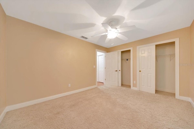 3769 Grove View Ln, Port Orange, FL 32129 - unfurnished bedroom with multiple closets, light colored carpet, and ceiling fan